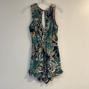 Illa Illa v-front, open back, ruffle bottom romper.